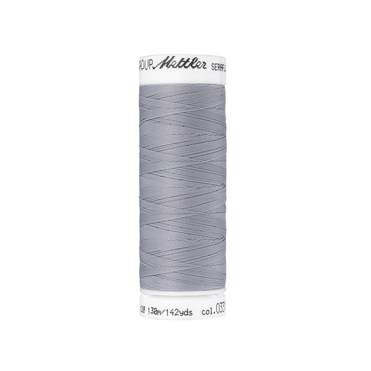 Spool of grey thread with Mettler Seraflex branding.