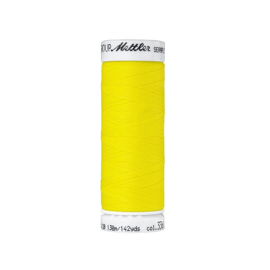Spool of yellow thread with Mettler Seraflex branding.