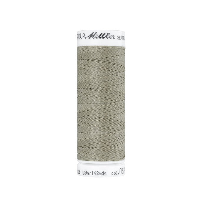 Spool of taupe  thread with Mettler Seraflex branding.