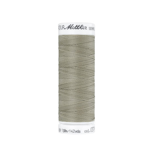 Spool of taupe  thread with Mettler Seraflex branding.