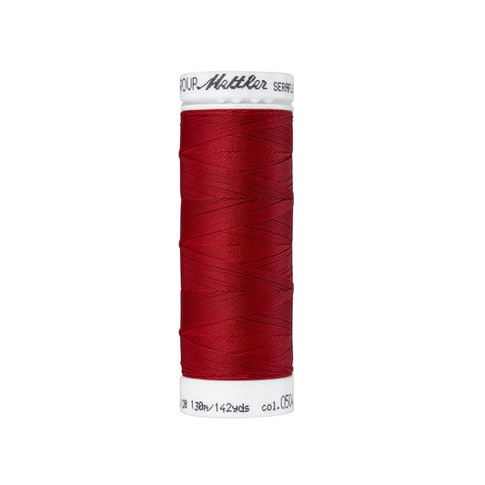 Spool of red thread with Mettler Seraflex branding.