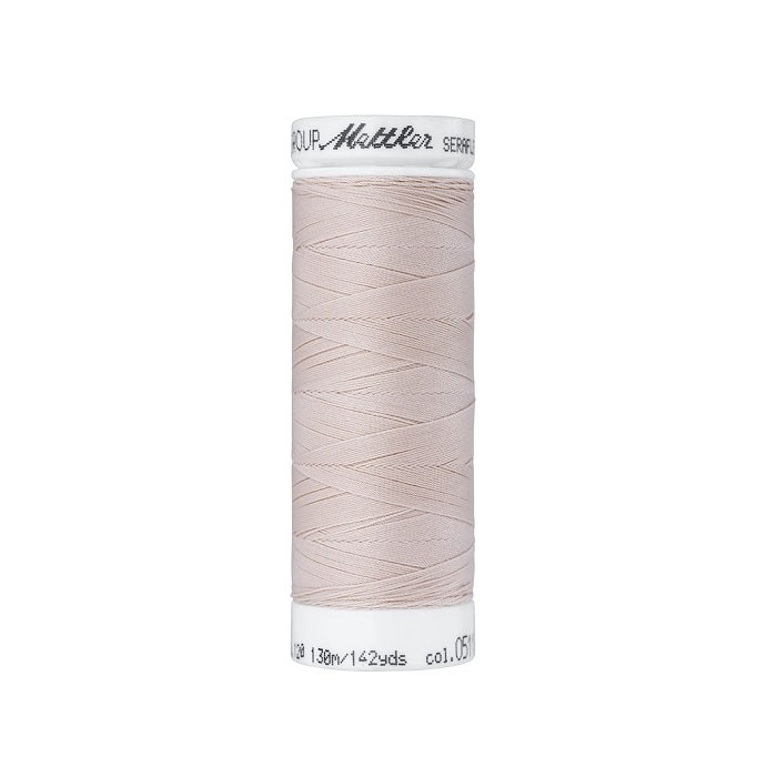 Spool of natural thread with Mettler Seraflex branding.