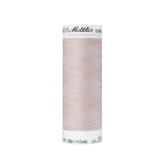 Spool of natural thread with Mettler Seraflex branding.