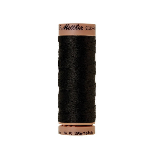 Spool of black cotton with Mettler branding.