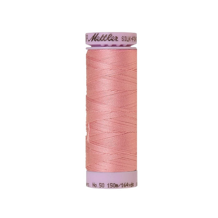 Pink thread with Mettler Cotton 50 branding.