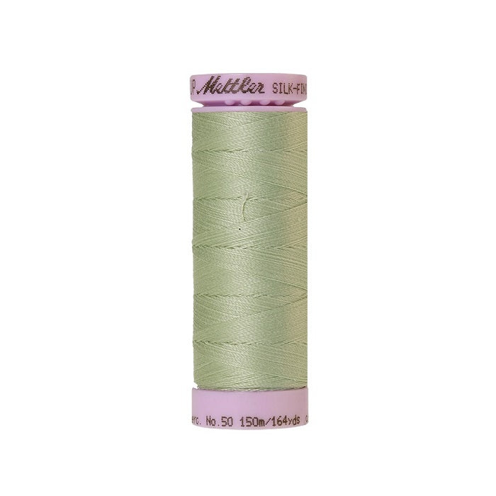 Light green thread with Mettler Cotton 50 branding.
