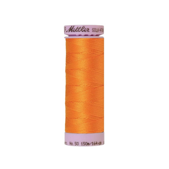 Orange thread with Mettler Cotton 50 branding.