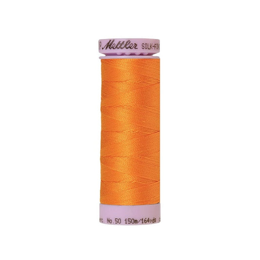 Orange thread with Mettler Cotton 50 branding.