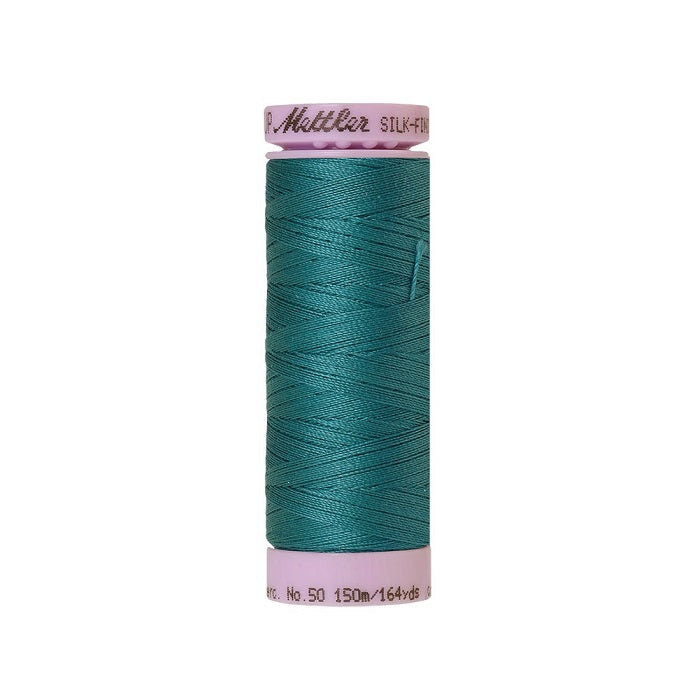 Teal blue thread with Mettler Cotton 50 branding.
