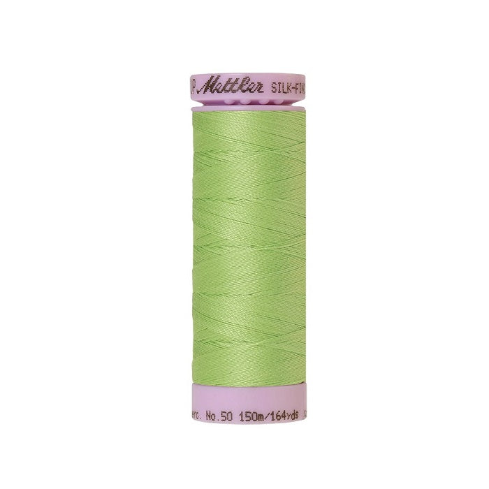 Lime green thread with Mettler Cotton 50 branding.