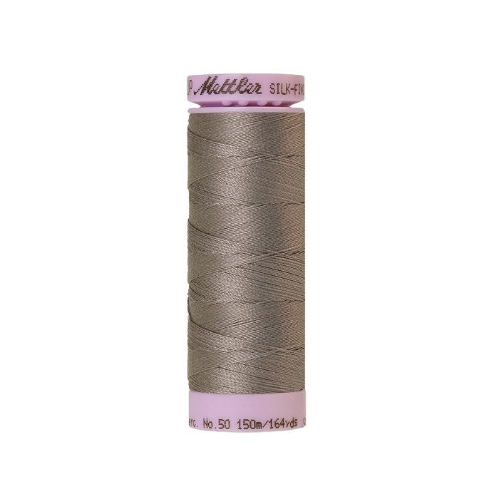 Beige thread with Mettler Cotton 50 branding.
