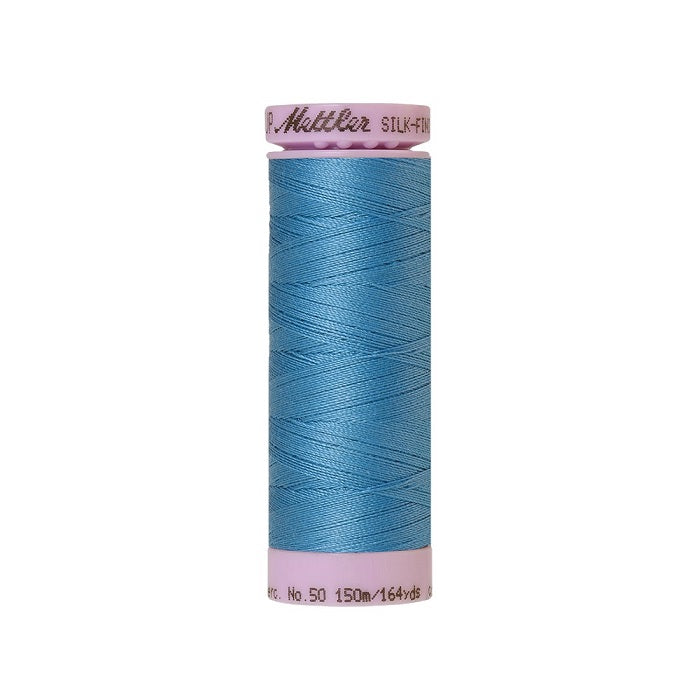 Blue thread with Mettler Cotton 50 branding.