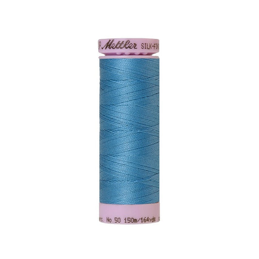Blue thread with Mettler Cotton 50 branding.