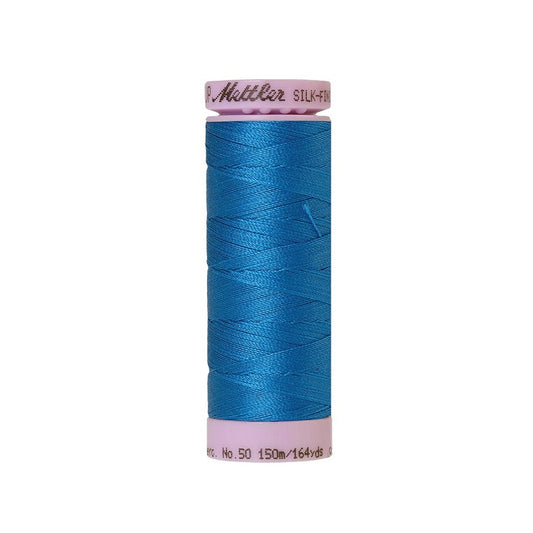 Blue thread with Mettler Cotton 50 branding.