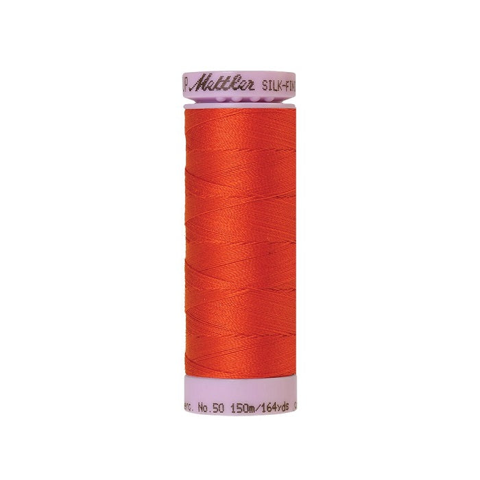 Orange thread with Mettler Cotton 50 branding.