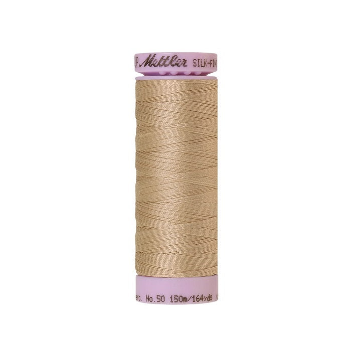 Beige thread with Mettler Cotton 50 branding.