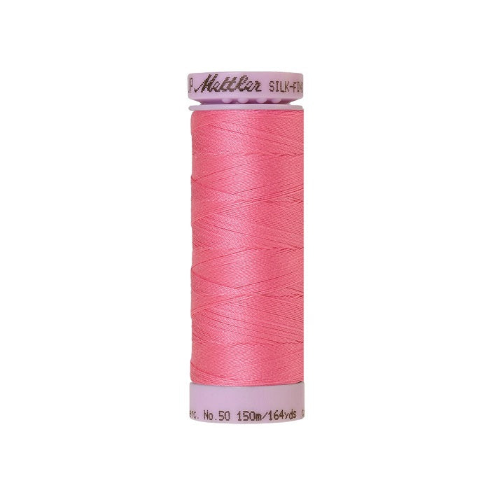 Pink thread with Mettler Cotton 50 branding.
