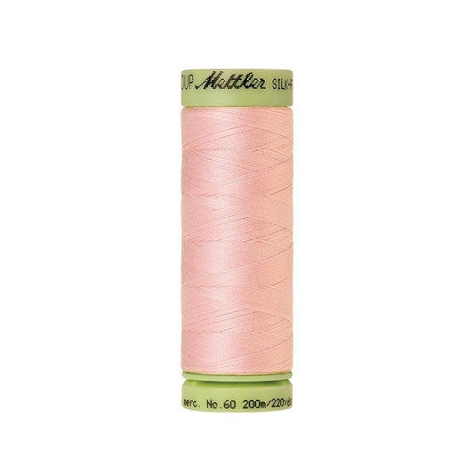 Pink thread with Mettler Cotton 60 branding.