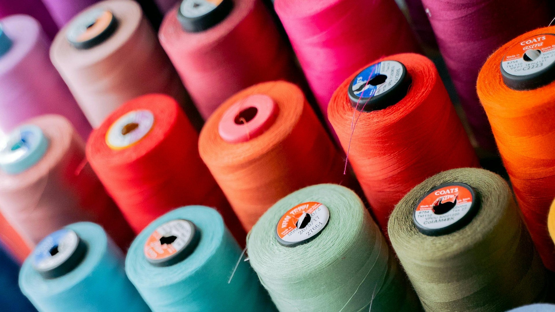 Assorted colourful cones of overlocking thread.