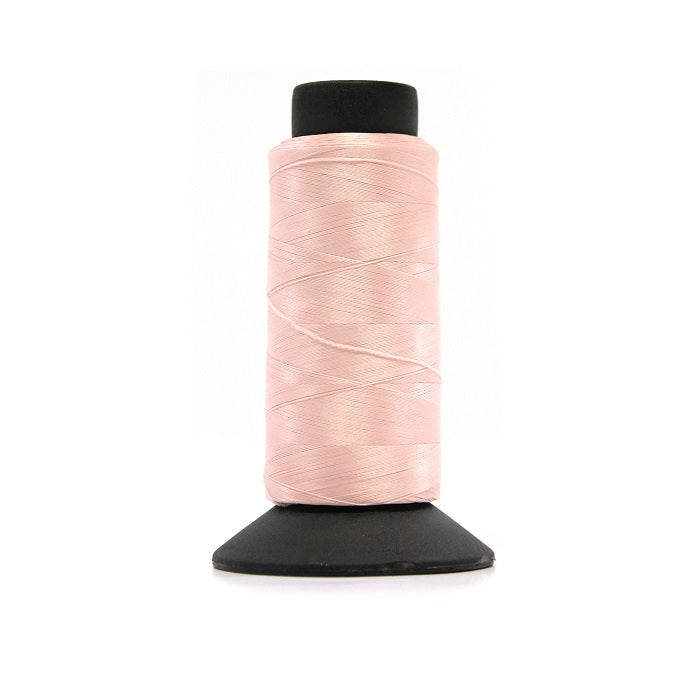 Cone of pink woolly nylon thread.