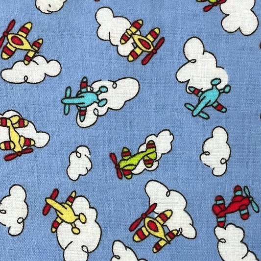 Colourful cartoon planes flying amongst clouds.