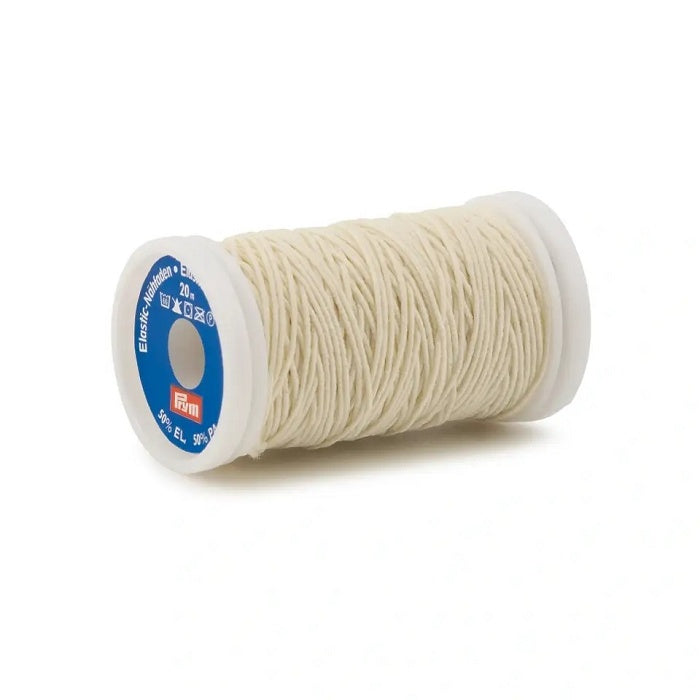 Spool of beige sewing elastic.
