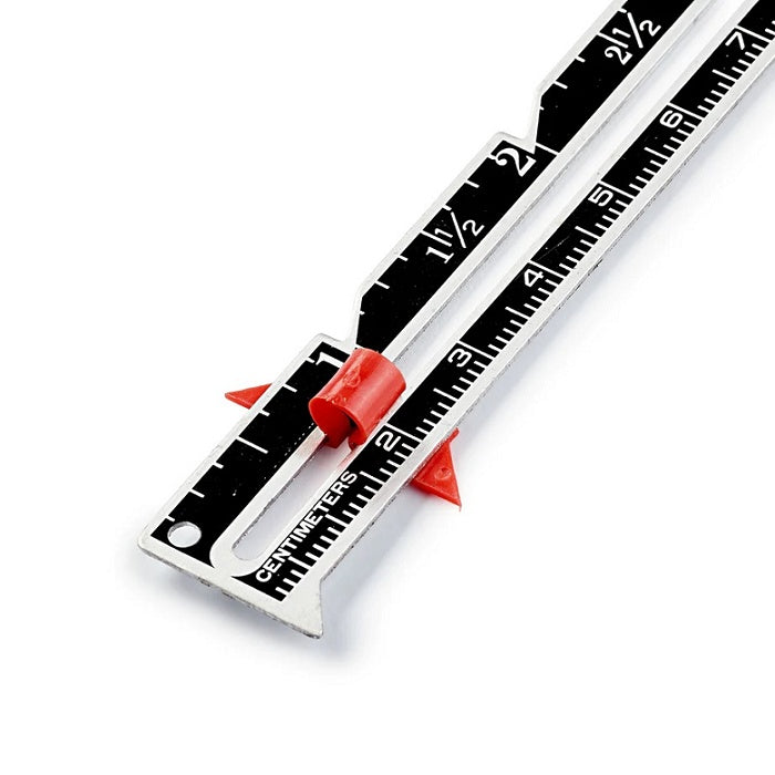 Black and silver metal hand gauge in inches and centimetres.