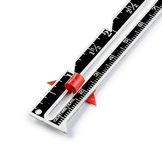 Black and silver metal hand gauge in inches and centimetres.