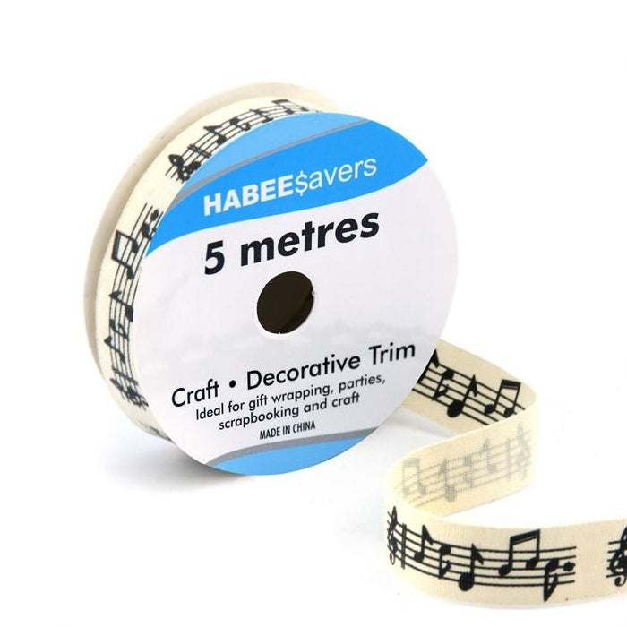Roll of cream ribbon with musical notes on a stave.