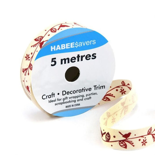 Roll of cream ribbon with red birds on a leafy garland.