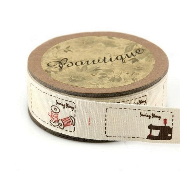 Spool of cotton ribbon with sewing themed tags.