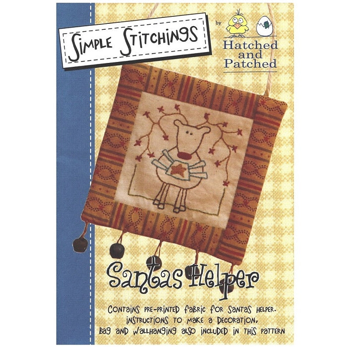 Pattern cover of wallhanging with embroidered reindeer and stars.