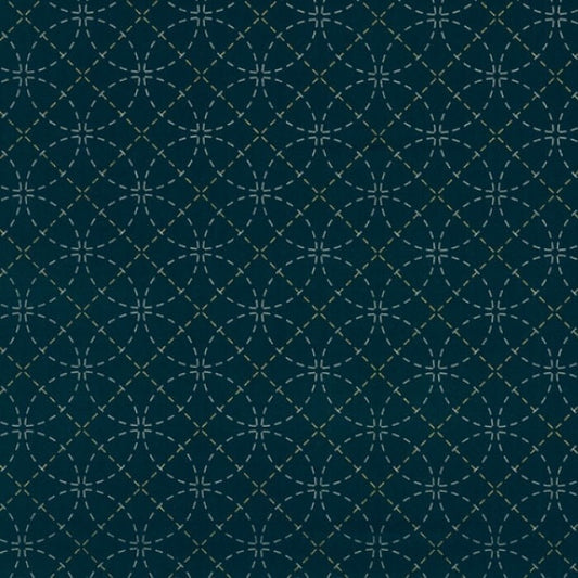 Circular stencil pattern on blue fabric.
