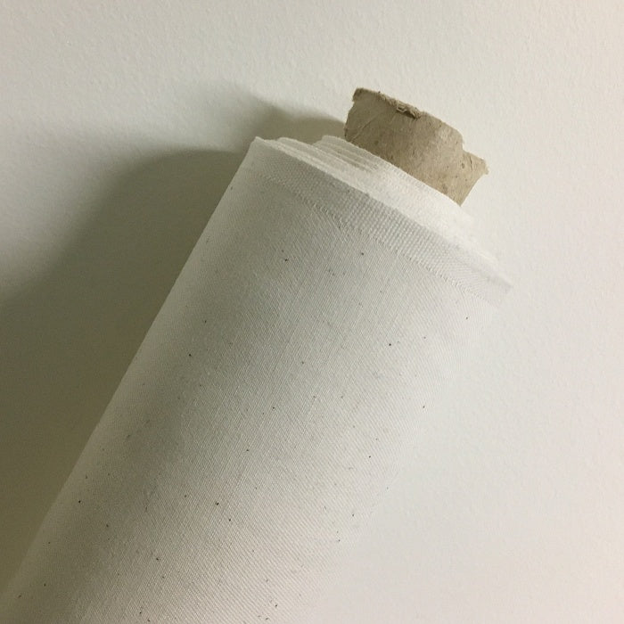 Roll of natural coloured fabric.