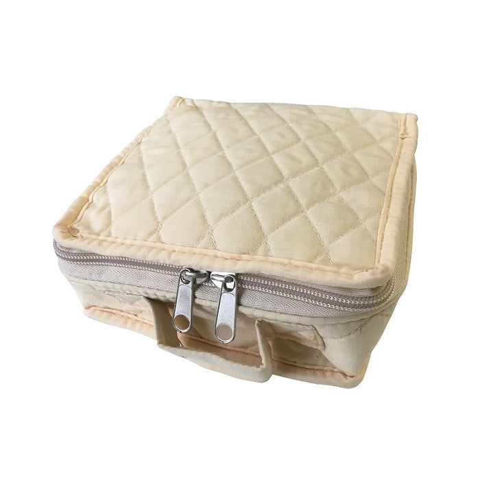 Square quilted beige pouch with a zipper and handle.