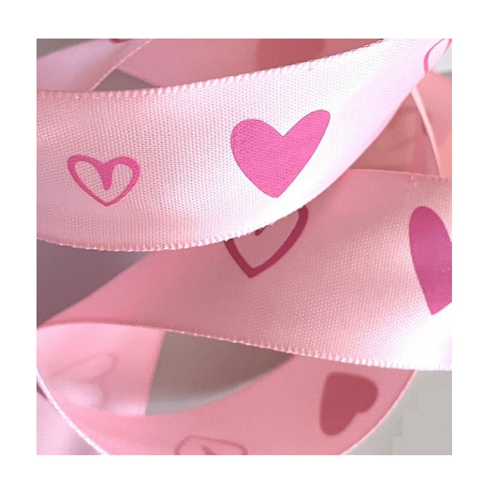 Light pink ribbon with printed pink hearts.