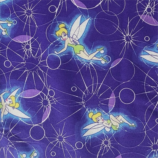 Dark purple fabric with Tinker Bell and geometric shapes.