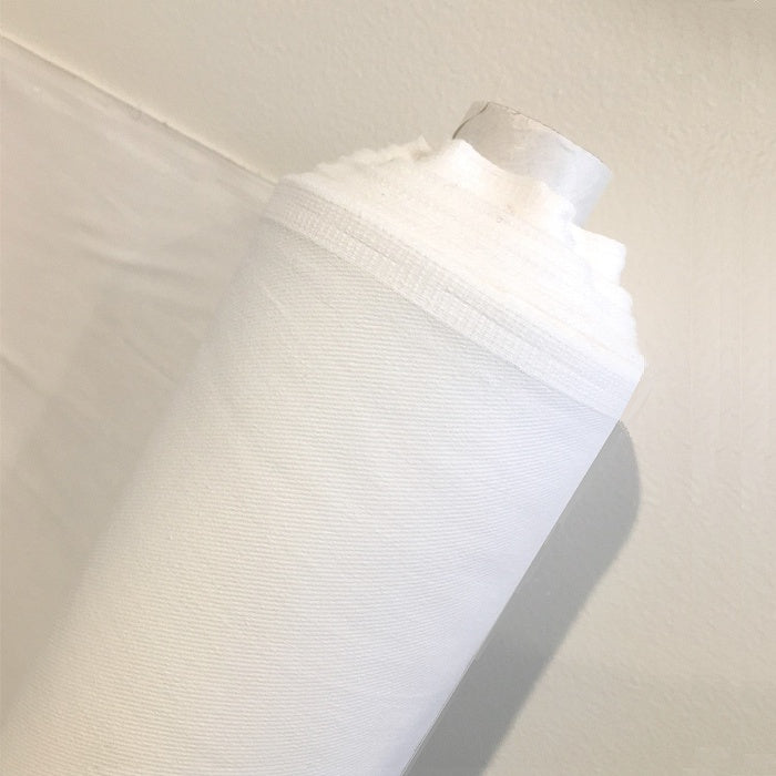 Roll of white fabric.
