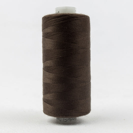 Spool of brown thread with Designer branding.