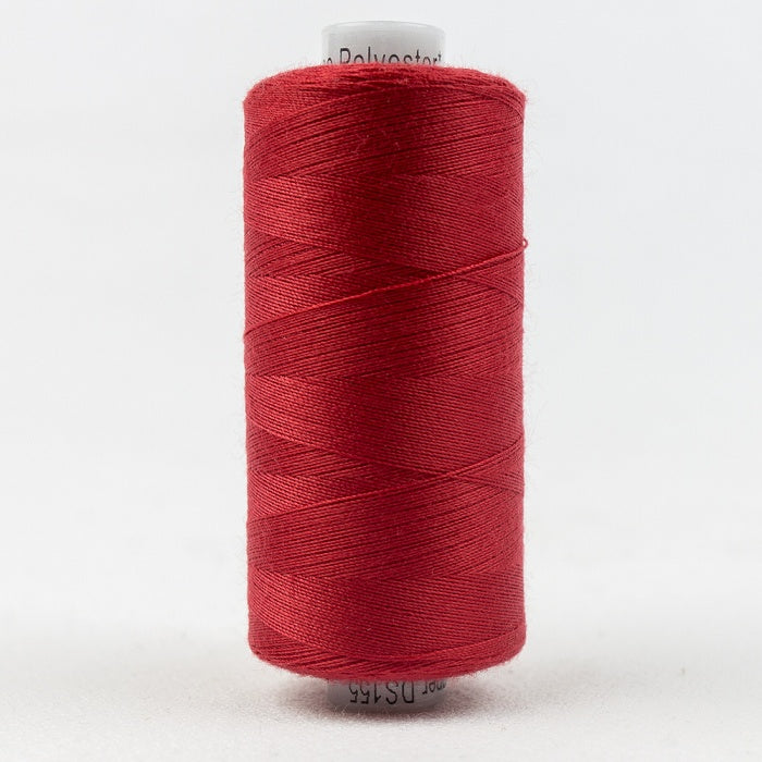 Spool of red thread with Designer branding.