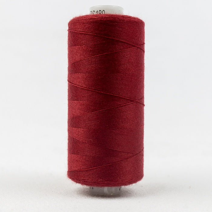 Spool of cherry red thread with Designer branding.