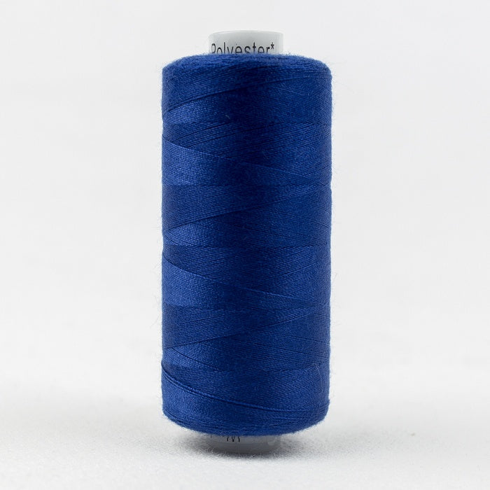 Spool of blue thread with Designer branding.