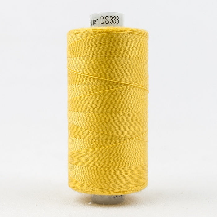 Spool of yellow thread with Designer branding.