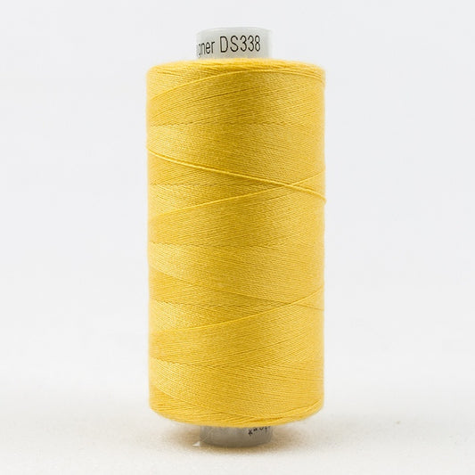 Spool of yellow thread with Designer branding.