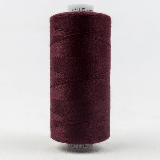 Spool of burgundy thread with Designer branding.