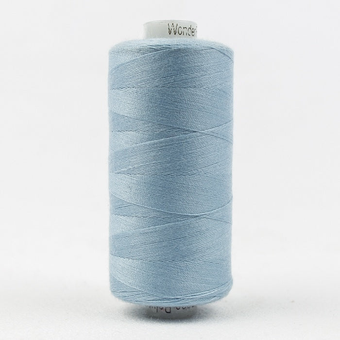 Spool of light blue thread with Designer branding.