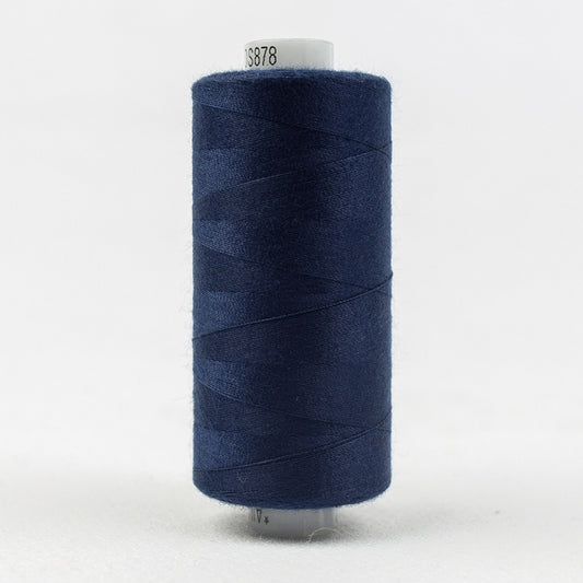 Spool of dark blue thread with Designer branding.