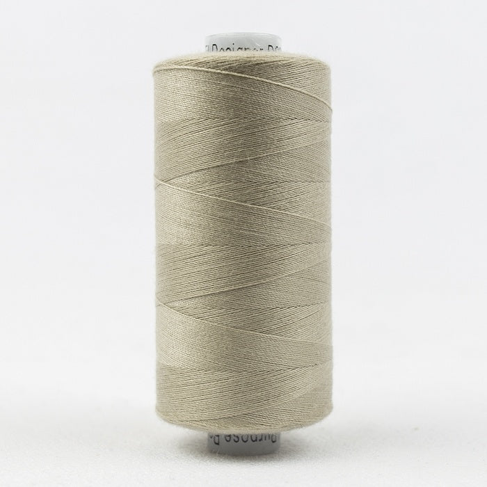 Spool of light beige thread with Designer branding.