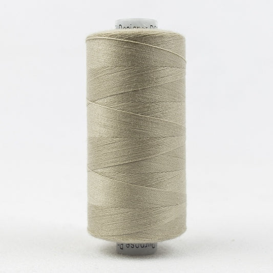 Spool of light beige thread with Designer branding.